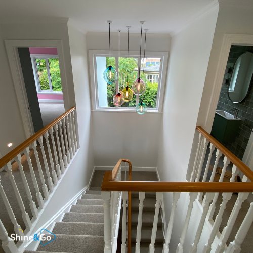 Stairwell with a glass pendant light fixture, cleaned by Shine&Go NZ