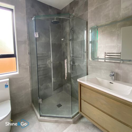 Bathroom with corner glass shower cleaned by Shine&Go NZ