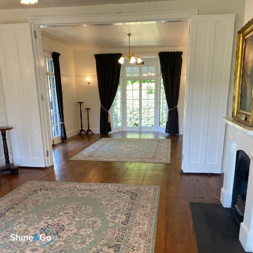 Formal living room with rugs and fireplace, cleaned by Shine&Go NZ