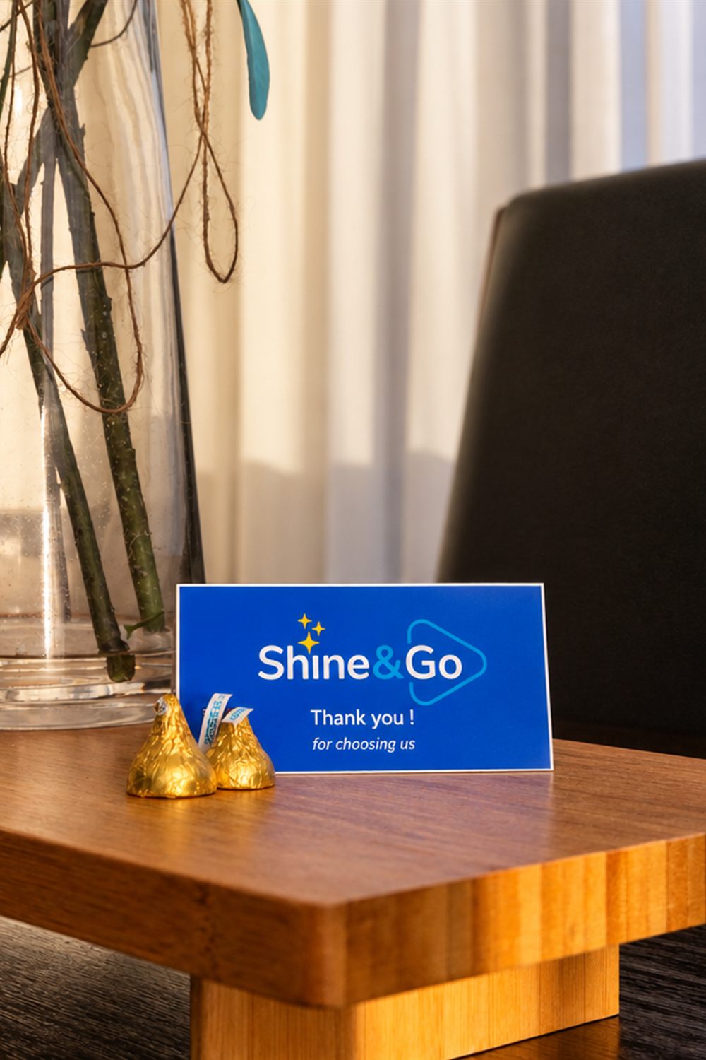 A Shine&Go NZ thank-you card and chocolates left on a client's table after a clean